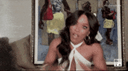 Celebrity gif. Angela Bassett jumps backwards in her chair, shaking her head quickly and holding her arms out in shock. Her eyes are wide and her lips twitch.