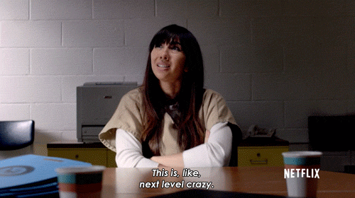 TV gif. Jackie Cruz as Marisol Gonzales in Orange Is the New Black sits at a desk and says, "This is, like, next level crazy," punctuating her statement with an okay sign with her hand.
