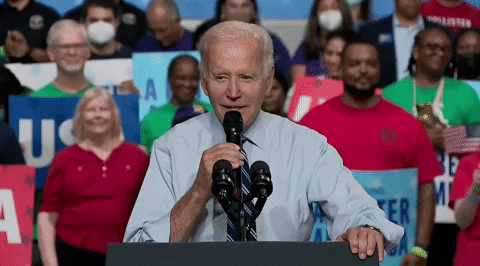 Politics gif. Joe Biden at a rally, with a crowd of people cheering behind him, speaking into a mic at a podium saying, "They are about to find out. Oh. Oh yeah. Oh yeah," which appears as text.