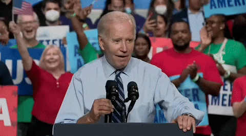Politics gif. Joe Biden at a rally, with a crowd of people cheering behind him, smiling while speaking into a podium mic saying, "Oh yeah. Oh yeah," which appears as text.
