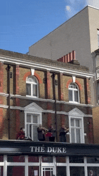 Band on Pub Roof Prepares to Cheer on London Marathon Runners