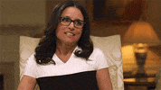 Celebrity gif. Julia Louis-Dreyfus scrunches up her face and squints upwards in contemplation.