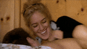 Reality TV gif. Heidi Montag on The Hills laughs as she cuddles onto a shirtless man who holds her under the arm.