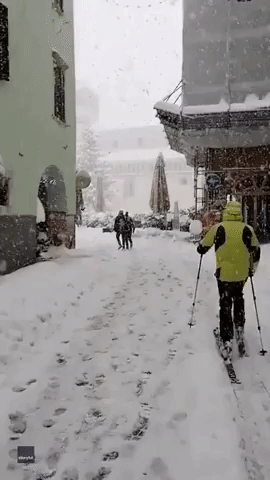 Skier Treks Through Snowy Piazza in Italian City of Trento