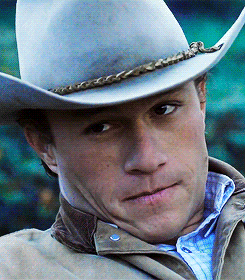 Movie gif. The gif switches between shots of Jake Gyllenhaal as Jack Twist and Heath Ledger as Ennis Del Mar in Brokeback Mountain as they look at one another in different shots. 