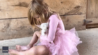 Little Girl Makes Up Lullaby to Serenade Baby Goat