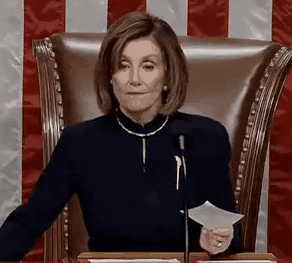 Political gif. Nancy Pelosi is at the podium holding a piece of paper and she purses her lips before raising her hand to silence someone.