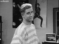 TV gif. Mark-Paul Gosselaar as Zack in Saved by the Bell looks at us and raises his eyebrows, shrugs, and smiles.