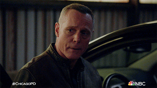 TV gif. Jason Beghe as Hank Voight from Chicago PD tilts his head towards his car.