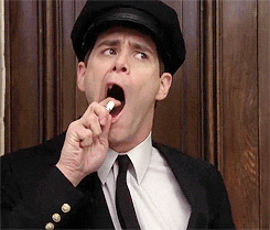Movie gif. Jim Carrey as Lloyd Christmas in Dumber and Dumber opens his mouth to the side and holds a  mouth spray, meant to freshen up his breath, up to his mouth. He spritzes it, but the nozzle is turned unknowingly to the side and spritzes out into the air. 