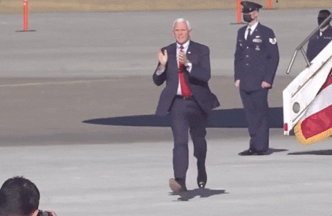 Political gif. Vice President Mike Pence jogs across the tarmac in a suit, clapping.