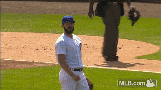 Sports gif. Jake Arrieta of the Chicago Cubs looks ahead, raises his arms and rolls his eyes in disappointment. 