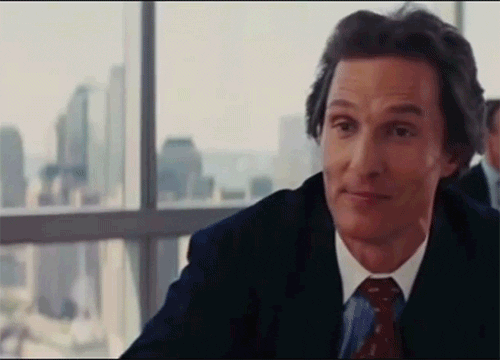 Movie gif. Matthew McConaughey as Mark Hanna in Wolf of Wall Street raises a martini and clinks glasses with Leonardo DiCaprio as Jordan Belfort.