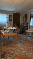Baby Laughs Hysterically as Sister Taps Her Head With Empty Bag