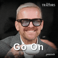 Sponsored gif. Traitors cast member Bob Harper looks bashful as he smiles and flicks his hand at someone. Text reads, “Go on.”