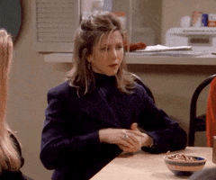 Friends gif. Jennifer Aniston as Rachel is dealing cards and she's an unexpected master at poker. The cards fly up impressively and she has a determined look on her face.