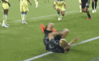 Sports gif. Walker Zimmerman from Nashville Soccer Club is on the field and he does a celebratory 2-fingered salute as he walks.