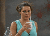 Reality TV gif. A contestant from Big Brother 17 is drinking a cup of water and bursts out laughing mid-sip. She sprays her water all over the counter and can't hold her laughter in, putting the cup down and backing away while laughing.