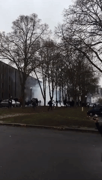 Student Protesters Run from Tear Gas in Paris Suburb