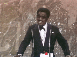 TV gif. Sammy Davis Jr. gives an excited speech at the 1972 Oscars. Text, "I'm so happy I could just woohoo!"