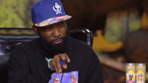 TV gif. Desus Nice points at someone and then points back to his lips like he’s applying chapstick. 