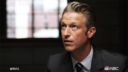 TV gif. Peter Scanavino as Dominick on Law and Order SVU glances to the side and smirks as if annoyed. 