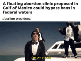 SNL gif. Andy Samberg sings “I’m on a boat” as Akiva Schaffer and rapper T-Pain dance atop a large white yacht behind him. Caption, “A floating abortion clinic proposed in Gulf of Mexico could bypass bans in federal waters. Abortion providers: I’m on a boat!”