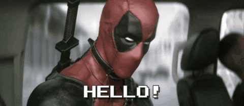 Movie gif. Ryan Reynolds as Deadpool glances up at us and waves his hand. Text, "hello!"