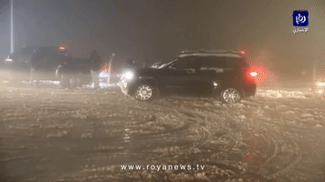 Cars Struggle on Snowbound Jordanian Motorway