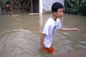 Locals Wade Through Flooded Streets in Cirebon, Indonesia