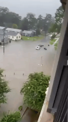 Person Swims Though Floodwaters on Street in Tuscaloosa