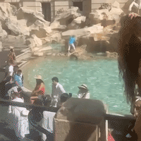 Woman Fills Bottle At Trevi Fountain
