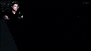 Celebrity gif. An image of Josh Hutcherson sexily resting his hands behind his head and smirking at us is magnified while a video of a man dramatically reacting to the image by throwing off his headphones plays in the corner. 