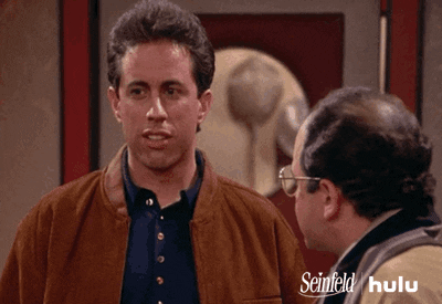 TV gif. Jerry Seinfeld as Jerry in Seinfeld looks down at George, eyes squinting brows knit, baffled, exclaiming "what?"