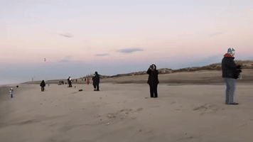 People Gather on Long Island Beach to Watch First Dawn of 2023