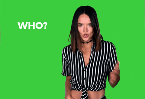 Celebrity gif. Against a solid green background, wearing a black-and-white striped half-shirt, Liz Huett puts a hand to her chest and playfully asks: Text, "Who me?"