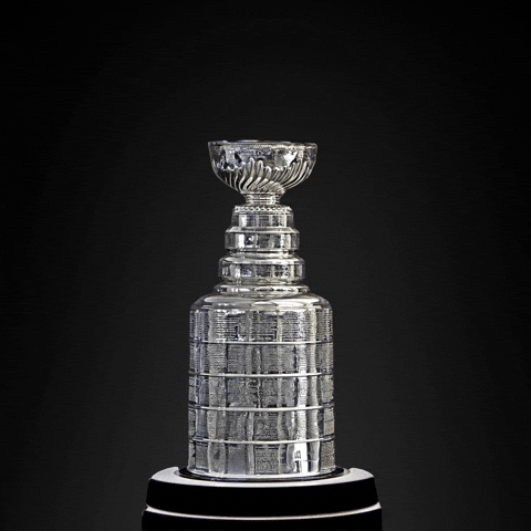 Sports gif. The Stanley Cup sits on a pedestal and slowly rotates while, "24" comes out on top.