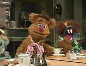Muppets gif. Fozzie Bear drops his head into his hand, covering his eyes and looking annoyed. 