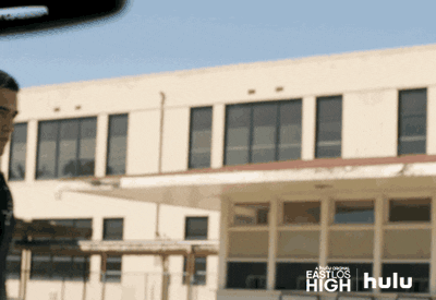 TV gif. Gabriel Chavarria as Jacob in East Los High. He walks in front of the school and waves hello to us eagerly.