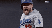 Sports gif. Los Angeles Dodgers player Max Muncy yells in triumph at the World Series.
