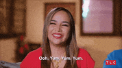 Reality TV gif. In a confessional, Annie Suwan from 90 Day Fiance smiles, her eyes closed. "Ooh. Yum yum yum," she says, which appears as text on screen. 