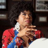 Reality TV gif. Michaela from Married at First Sight is over it, as she rolls her eyes heavily as she sits at a table.