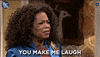 Tonight Show gif. Oprah says to someone, “you make me laugh.” and then she over exaggeratedly laughs, tilting her head back and moving her hand over her head as she laughs.