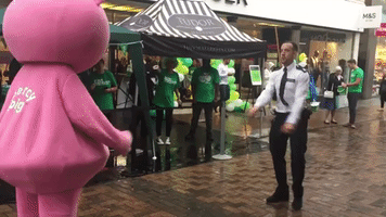 Police Officer and Giant Pig in Dance-Off For Charity