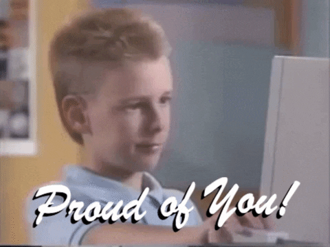 Video gif. A young boy stares at a computer before looking up and nodding while giving us a proud, half smile and a thumbs up. Text, "Proud of You!" 