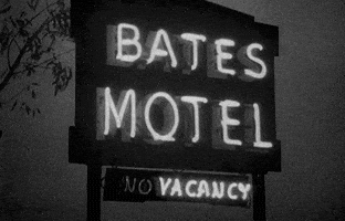 Movie gif. From Psycho, a shot of the neon-lit Bates Motel sign, with the word "vacancy" flashing on the "no vacancy" sign.