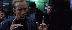Movie gif. Nicolas Cage as Randall Raines in Gone in 60 Seconds looks tough and confident in a black leather jacket as he motivates a group by shaking his hands and saying "Ok let's ride," which appears as text.