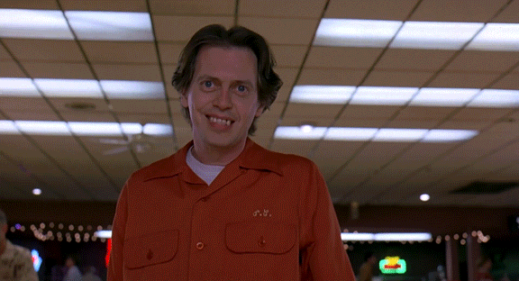 Movie gif. Steve Buscemi as Theodore in The Big Lebowski watches his bowling ball hit the pins and he excitedly reacts, shaking his body, and then happily walking back to his seat.