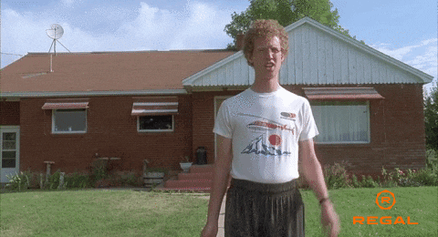 Movie gif. Standing in front of his home, Jon Heder as Napoleon Dynamite awkwardly waves and says "hi." 