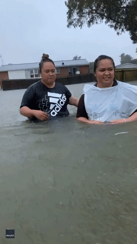 'Hey Brother, You Can't Park Here!' Kiwi Family in Good Spirits Wading Through Waist-High Water